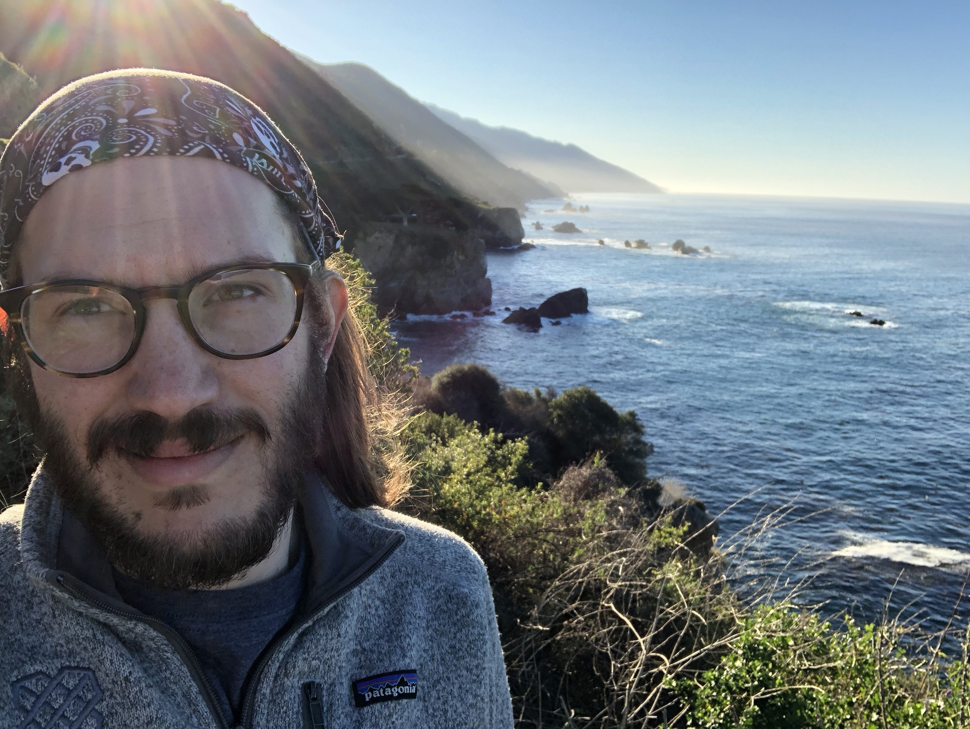 Me in front of Big Sur coastline near McWay Falls